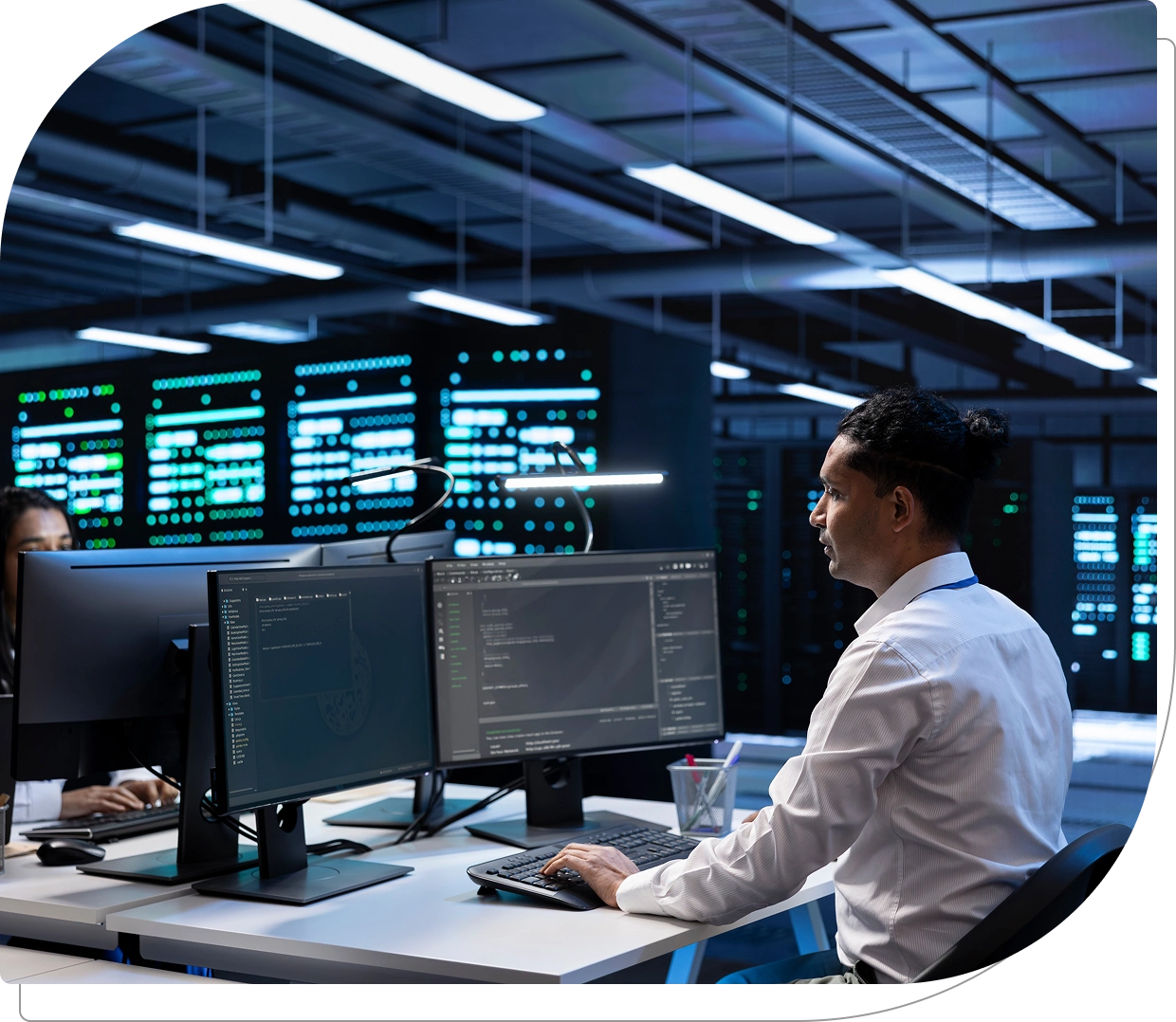 Man working at computer in data center.